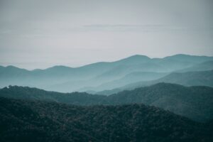 A foggy mountainous scenery under the gloomy sky